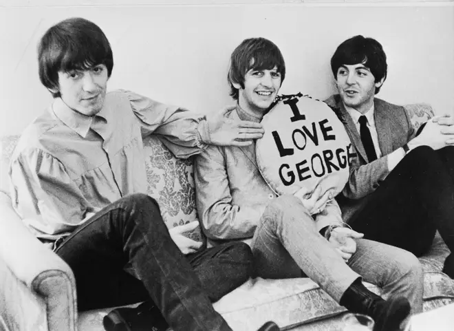 Three of the four members of the British rock group The Beatles in 1964