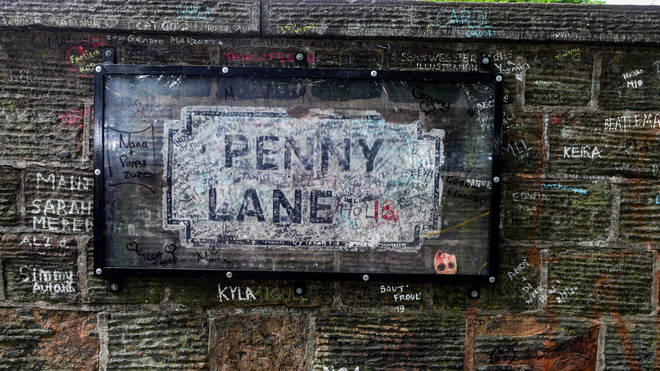 A protected sign on Penny Lane, signed by The Beatles' Paul McCartney, after graffiti was removed
