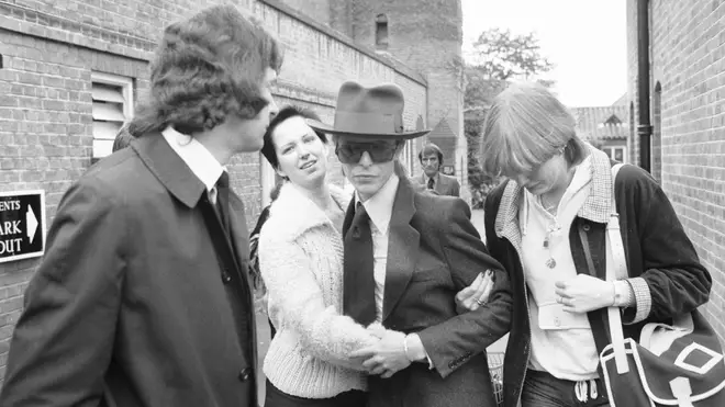 David Bowie being accosted by mourning fans at Marc Bolan's funeral.