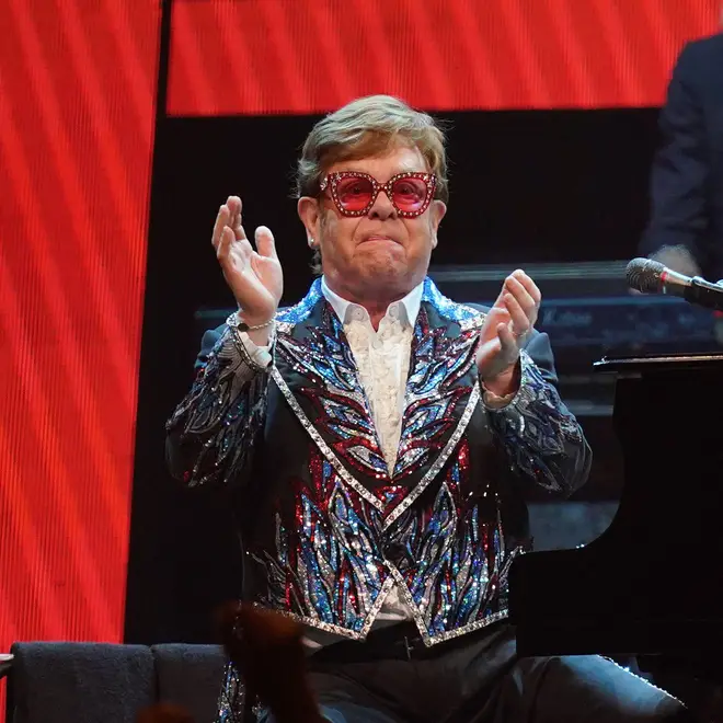 Elton John applauds the crowd at the last show of the Farewell Yellow Brick Road tour