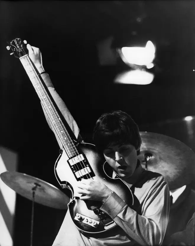 Paul McCartney tuning his Hofner 500/1 violin bass guitar in 1964