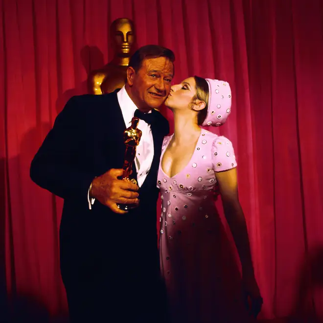 John Wayne gets the Oscar (and a kiss) from Barbra Streisand