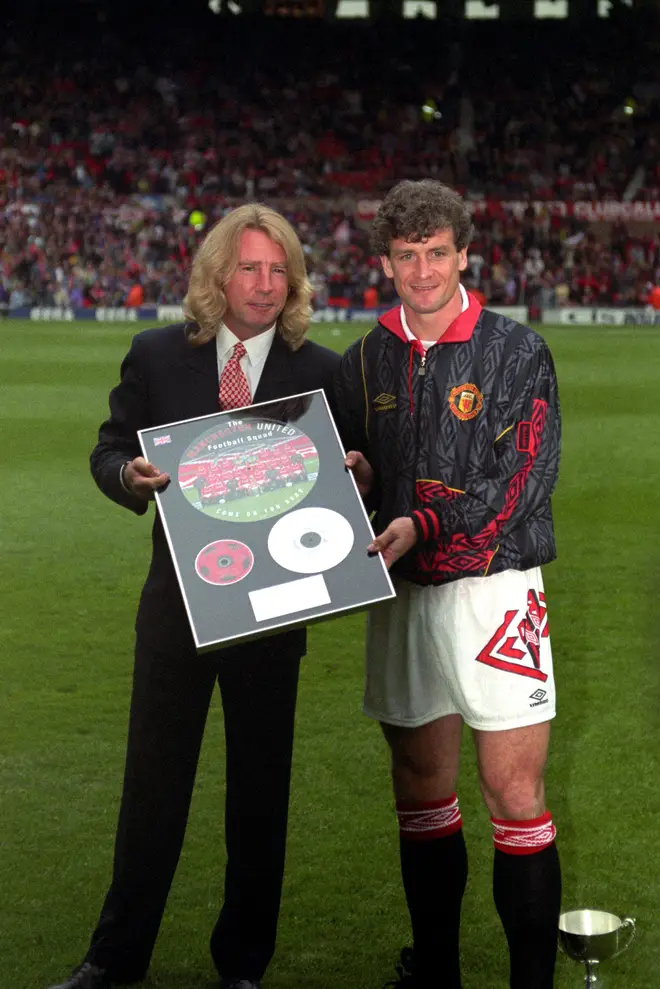 Mark Hughes presents Rick Parfitt with a Gold Disc at Old Trafford
